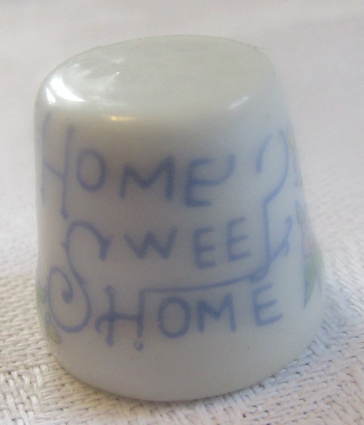 Fingerbøl i porcelæn, med skriften Home sweet home